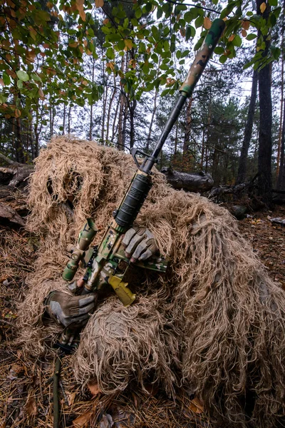 Sniper reload his rifle in forest Stock Photo by ©Nesterenko_Max 89103288